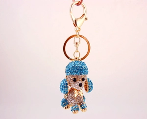 Detail of a sparkling crystal dog keychain featuring blue and silver rhinestones