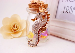 Close-up of golden seahorse keychain with sparkling rhinestones and crown detail