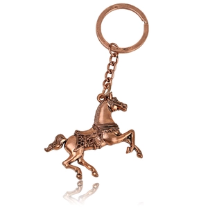 Creative bronze galloping horse keychain with vintage metal alloy finish on white background