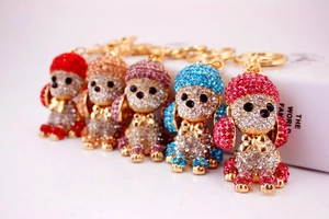 Detail showing five colorful crystal poodle keychains with vibrant rhinestones and gold metal