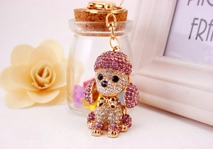 Macro shot of gold dog keychain with sparkling pink and white crystals detail