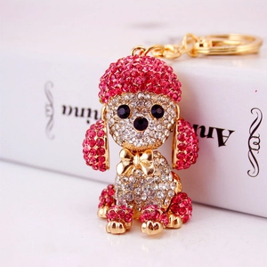Pink and white crystal rhinestone poodle dog keychain with gold bow tie detail