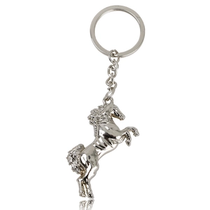 Macro detail of a silver metallic horse-shaped keychain with polished finish and keyring