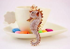 Detailed shot of golden seahorse keychain with crown and sparkling inlaid rhinestones