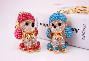 Sparkling pink and blue crystal dog keychains in a shiny gold-tone metal setting