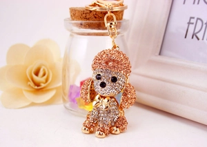 Close-up of a sparkling gold and silver crystal encrusted poodle dog keychain accessory
