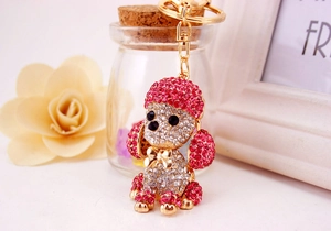 Detail of crystal dog keychain with pink rhinestones, gold bow, and lobster clasp