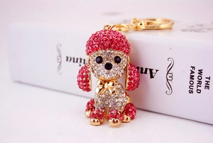 Close-up of pink crystal poodle keychain with sparkling rhinestones on golden metal base