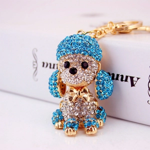 Golden crystal poodle keychain with blue rhinestones and elegant sparkling dog pendant