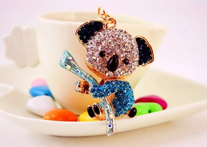Macro shot of rhinestone-encrusted koala keychain with blue and clear sparkling crystals