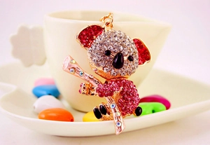 Detailed view of koala keychain with vibrant red and white rhinestones on gold metal base