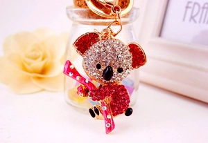 Detail of koala keychain with red and clear rhinestones on a gold-plated metal base
