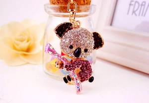 Detailed view of koala keychain with pink and white rhinestones on a golden metal base