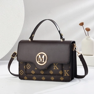 Classic dark brown crossbody bag with floral monogram print and golden M buckle