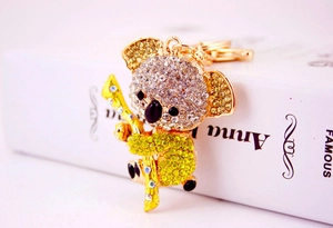 Macro shot of gold koala keychain with sparkling rhinestones and crystal details
