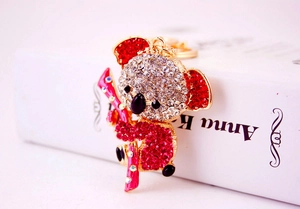 Close-up of golden koala keychain featuring sparkling red and white rhinestones