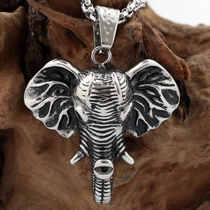 Polished silver titanium steel elephant head pendant with box chain on natural wood