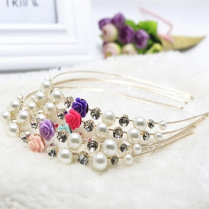 Detail of floral headbands with white pearls, rhinestones and colorful mini cloth roses