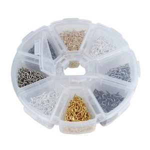 Detailed view of DIY eye pins in various metallic colors organized in a round storage case