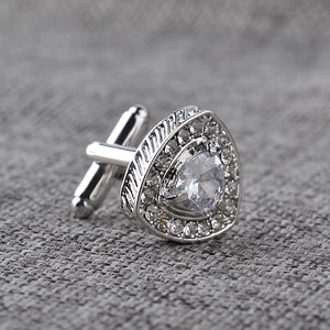 Macro shot of silver cufflinks with teardrop crystal and surrounding zircon settings