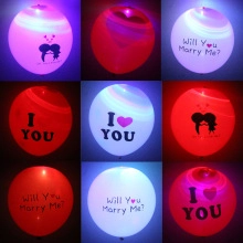 Detail of red and white LED glowing latex balloons with I Love You and Marry Me prints