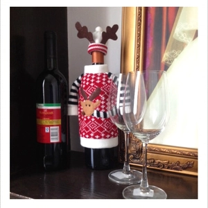 Knitted Christmas wine bottle cover set with reindeer pattern and matching mini hat