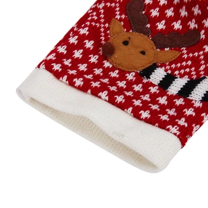 Macro shot of Christmas wine bottle cover featuring knit patterns and reindeer felt patch