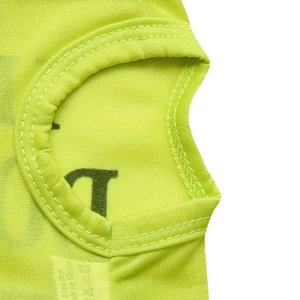 Macro shot of breathable neon yellow mesh fabric with durable double stitching on dog vest