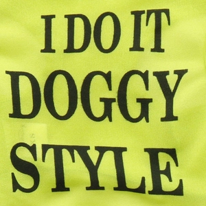 Close-up of breathable neon yellow mesh fabric with black text for pet vest