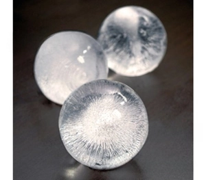 Detailed view of clear spherical ice balls made from a silicone ice cube mold set