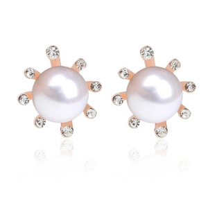 Detailed close-up of crystal rhinestone earrings with white pearl and rose gold finish
