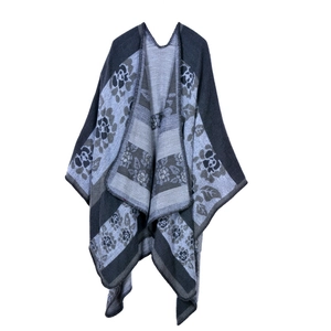 Detailed close-up of blue and grey floral knit pattern on heavy winter shawl poncho