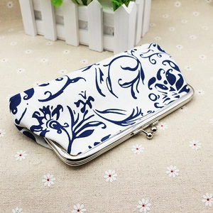 Macro detail of blue and white floral canvas coin purse with silver metal kiss-lock clasp
