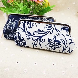 Close-up of vintage fabric coin purses with floral patterns and silver metal clasps
