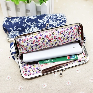 Detail view of ethnic floral fabric coin purse showing internal capacity and metal clasp