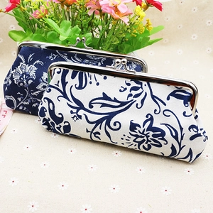Close-up of ethnic fabric coin purses with metal clasps and blue floral pattern