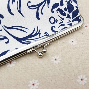 Close-up of vintage blue and white floral fabric coin purse with silver metal kiss-lock