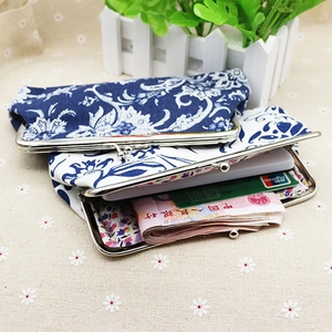 Ethnic fabric coin purse with vintage metal clasp and blue floral prints on beige textile