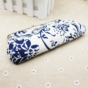 Detailed side view of blue floral fabric coin purse with vintage silver metal clasp