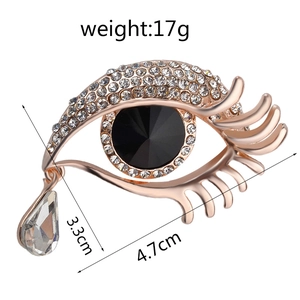 Detailed view of the rhinestone eye brooch with dimensions 4.7cm by 3.3cm and 17g weight