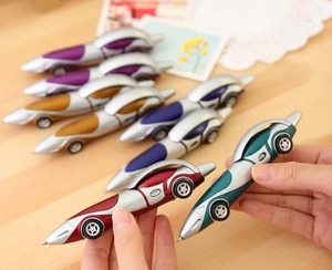 Close-up of assorted colorful racing car shaped plastic ballpoint pens with wheels