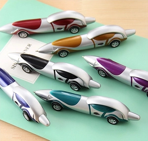 Detailed view of six creative racing car ballpoint pens in various colors on a notebook