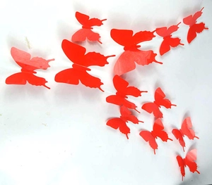 Detail of red 3D PVC butterfly wall stickers in various sizes on a white background