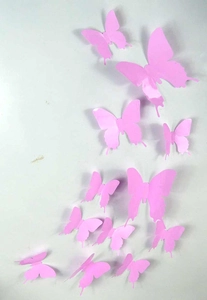 Close-up of pink 3D butterfly wall stickers in various sizes with realistic wing fold