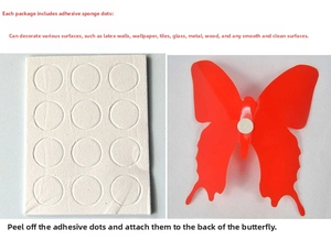 Detail showing adhesive foam pads application process for red 3D butterfly wall stickers