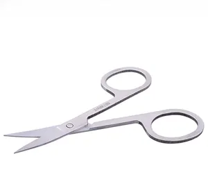 Detailed macro view of curved stainless steel beauty scissors with silver mirror finish