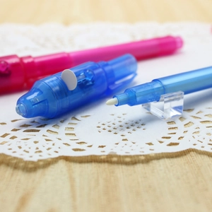 Close-up of pink and blue creative car-shaped pens on a small display stand