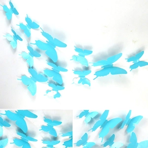 Detail view of 3D blue PVC butterflies arranged in a flying pattern on a white wall