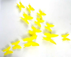 Detail of yellow 3D PVC butterfly wall stickers showing realistic folding wings on wall