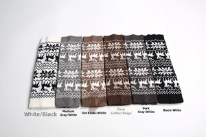 Close-up of winter knitted leg warmers with Nordic elk and snowflake jacquard patterns